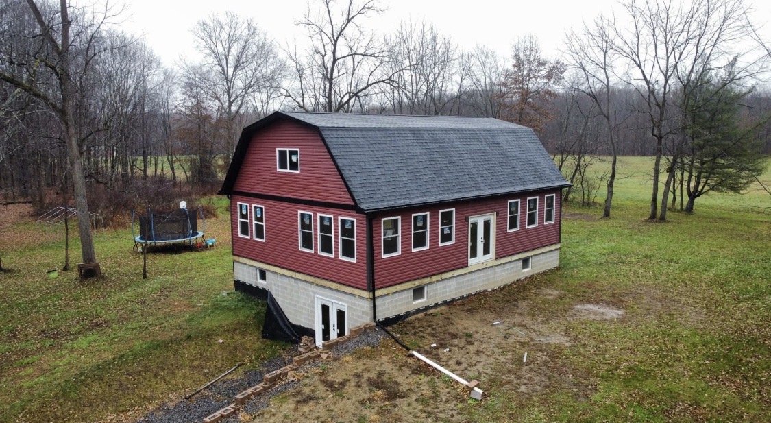 Barn-style building with new roof and siding by H&H Construction, New Castle PA